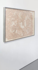 Horizontal brain-looking maze made of copper wires on a canvas panel and mounted on a steel frame.